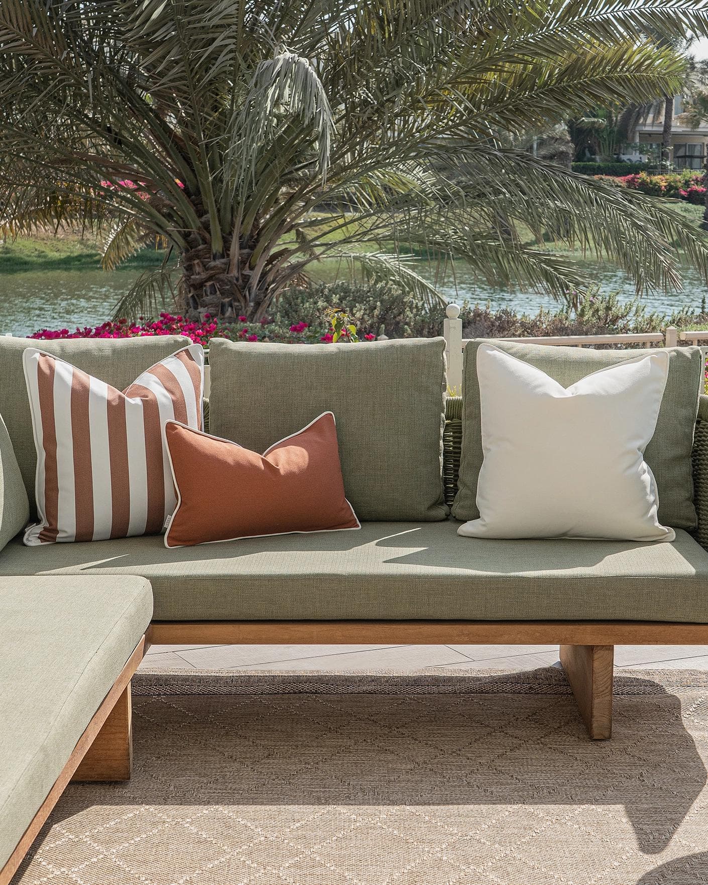 Haneen Bundle cushion in rust and ivory, shown in a lifestyle front view as image 4
