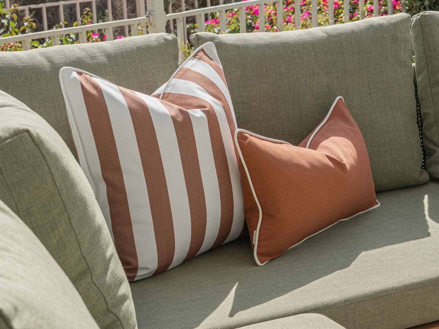 Haneen Bundle cushion in rust and ivory, shown in a lifestyle left view as image 5