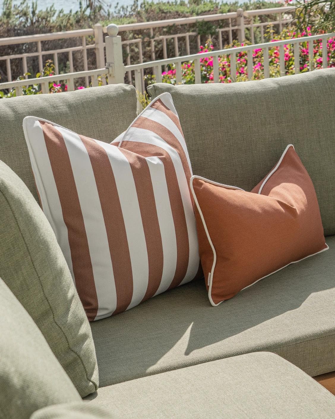 Haneen Bundle cushion in rust and ivory, shown in a lifestyle left view as image 5