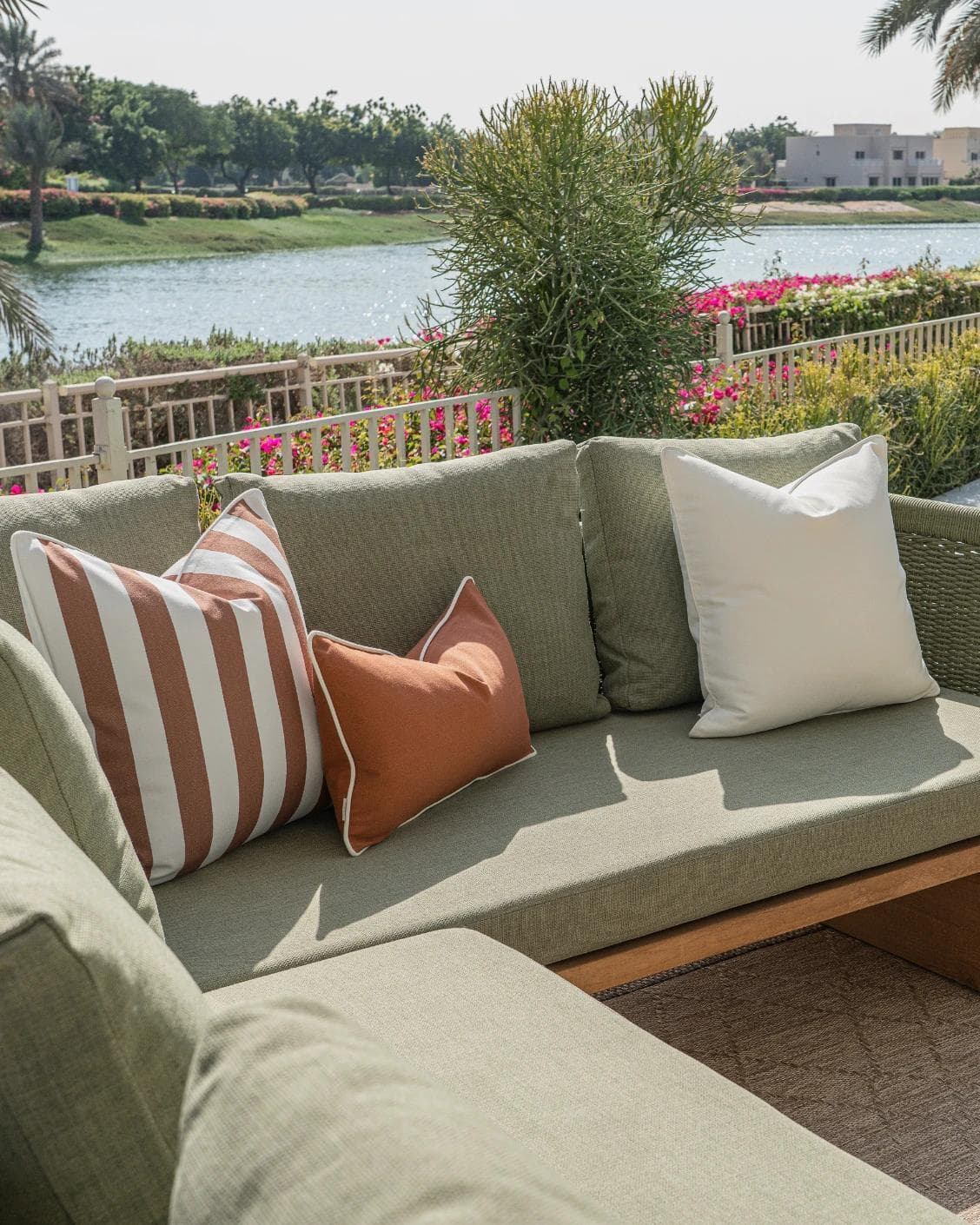 Haneen Bundle cushion in rust and ivory, shown in a lifestyle left view as image 2