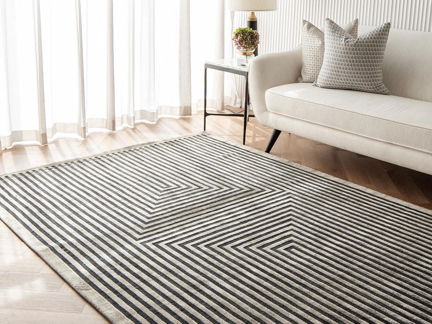 Harf Noon Ebony carpet in charcoal, shown in a lifestyle right view as image 5