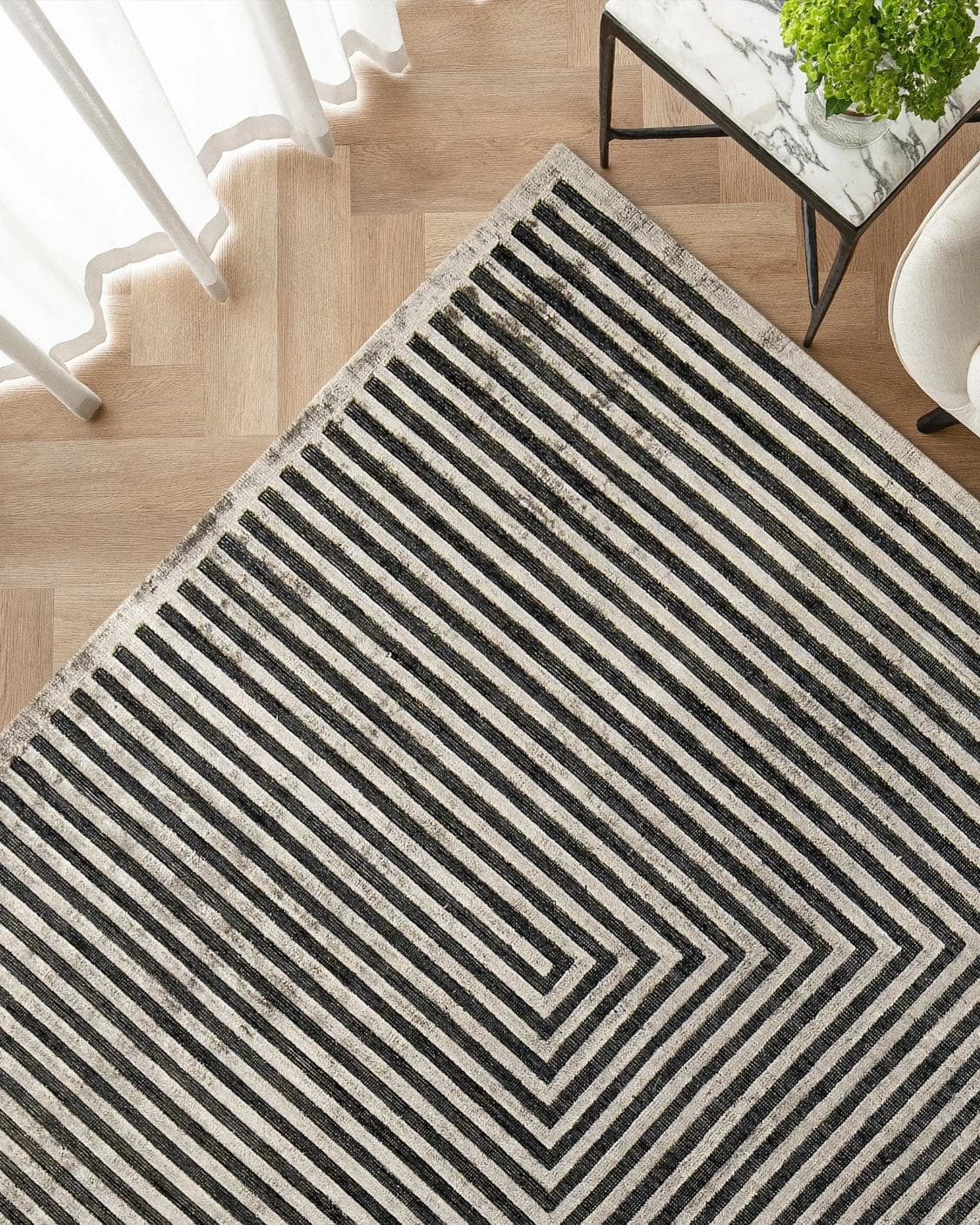 Harf Noon Ebony carpet in charcoal, shown in a lifestyle top view as image 2