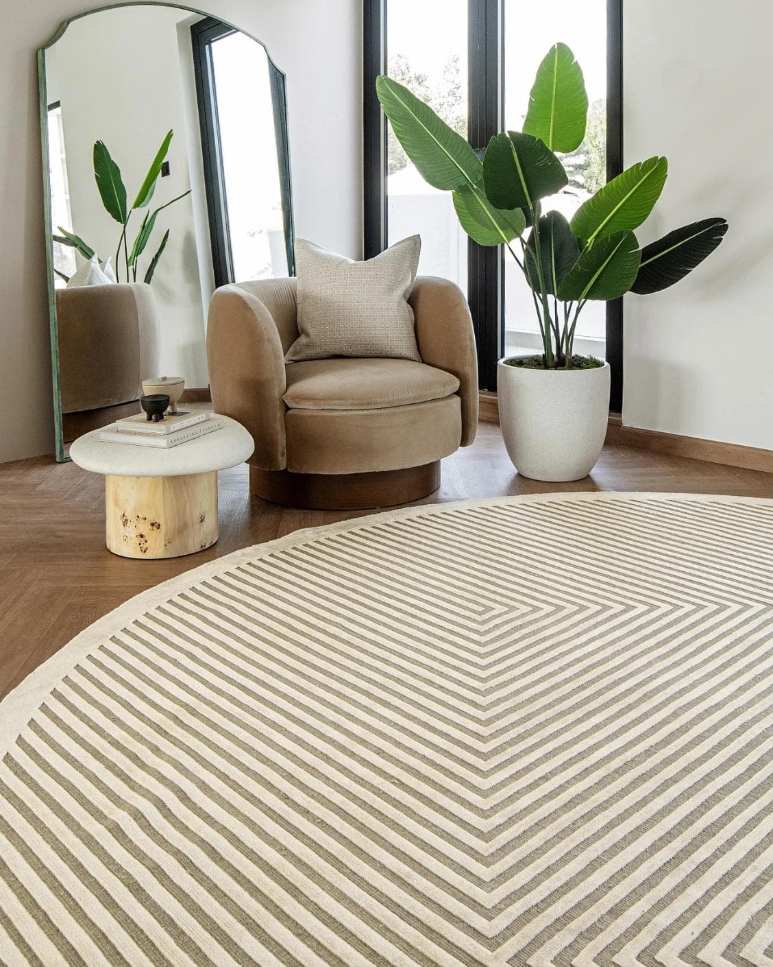 Harf Noon Sandy Round carpet in beige and ivory, shown in a lifestyle front view