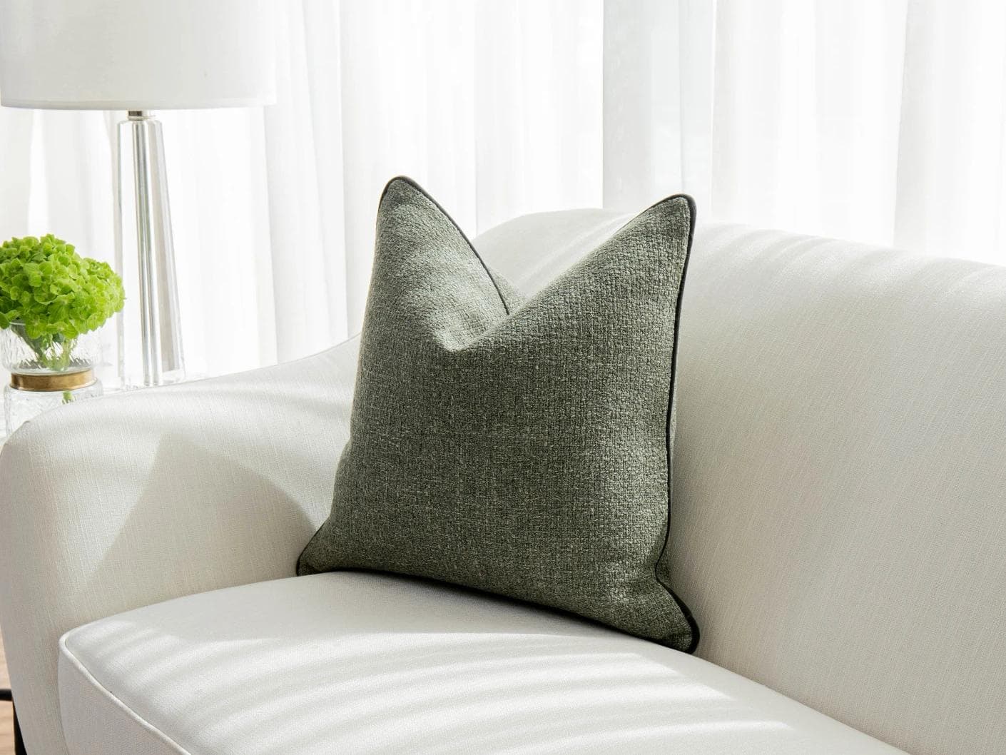 Harrison Sage cushion in green, shown in a lifestyle front view as image 2