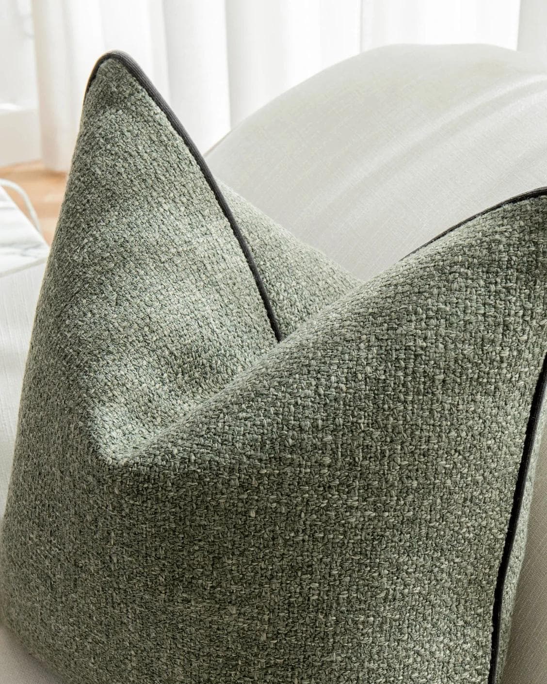 Harrison Sage cushion in green, shown in a lifestyle top view as image 5