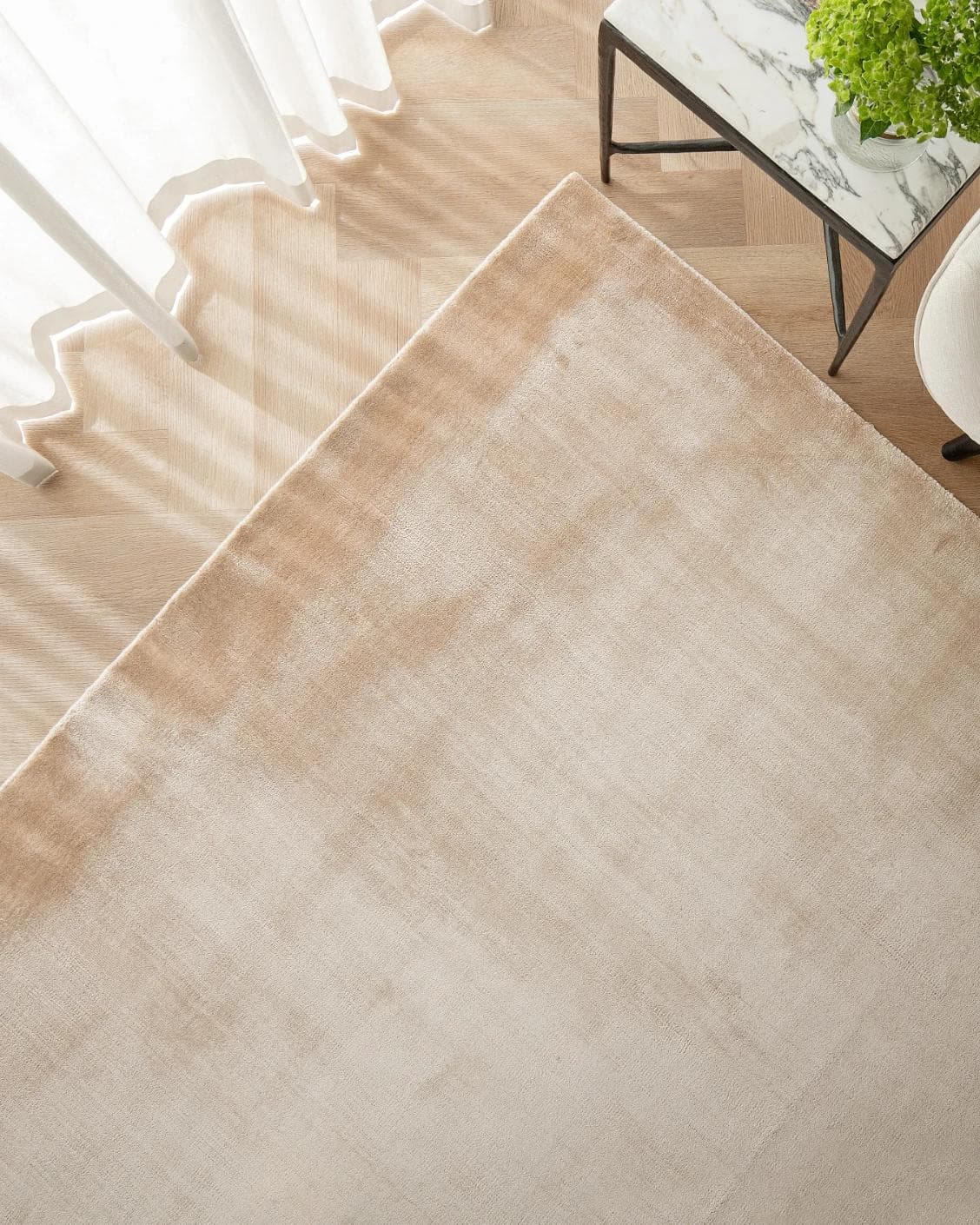 Hartman Sandy carpet in beige, shown in a lifestyle top view as image 2