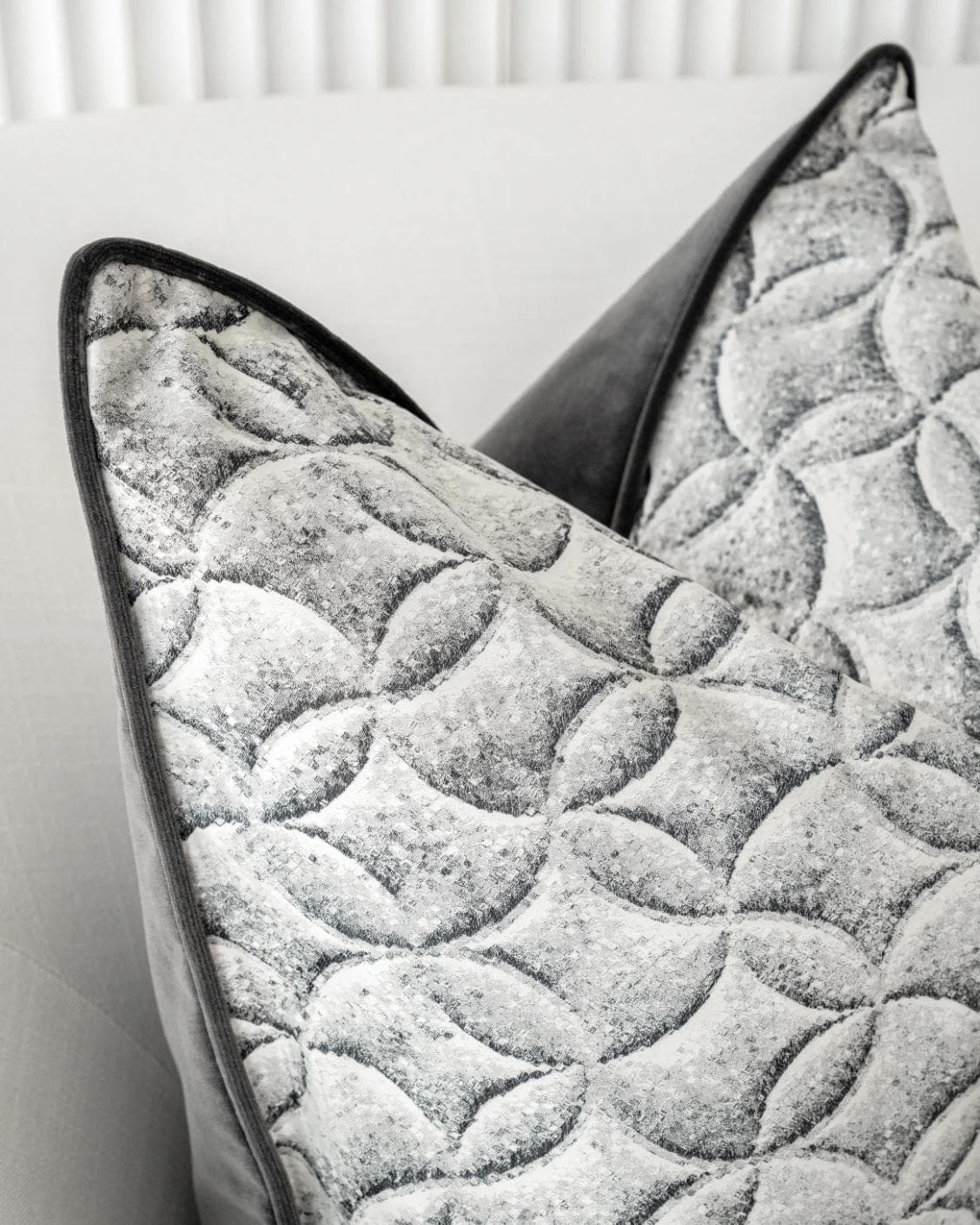 Heera Steele cushion in white and black, shown in a lifestyle left view as image 6