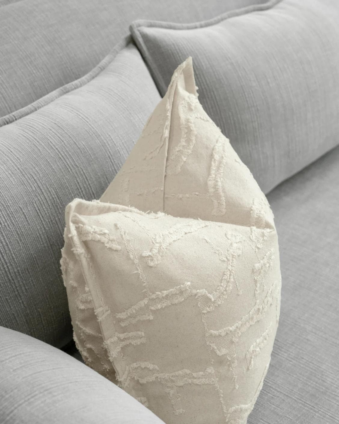 Heeth Laurent cushion in cream and ivory, shown in a lifestyle top view as image 5