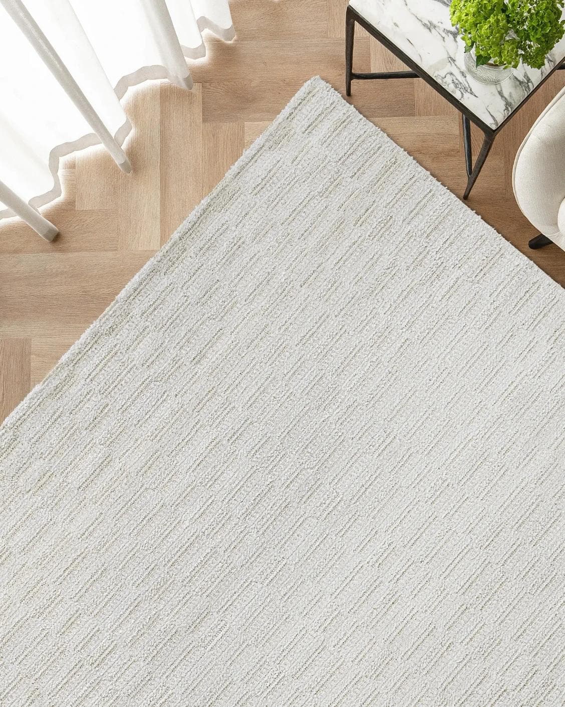 Henry Dune carpet in beige, shown in a lifestyle top view as image 2