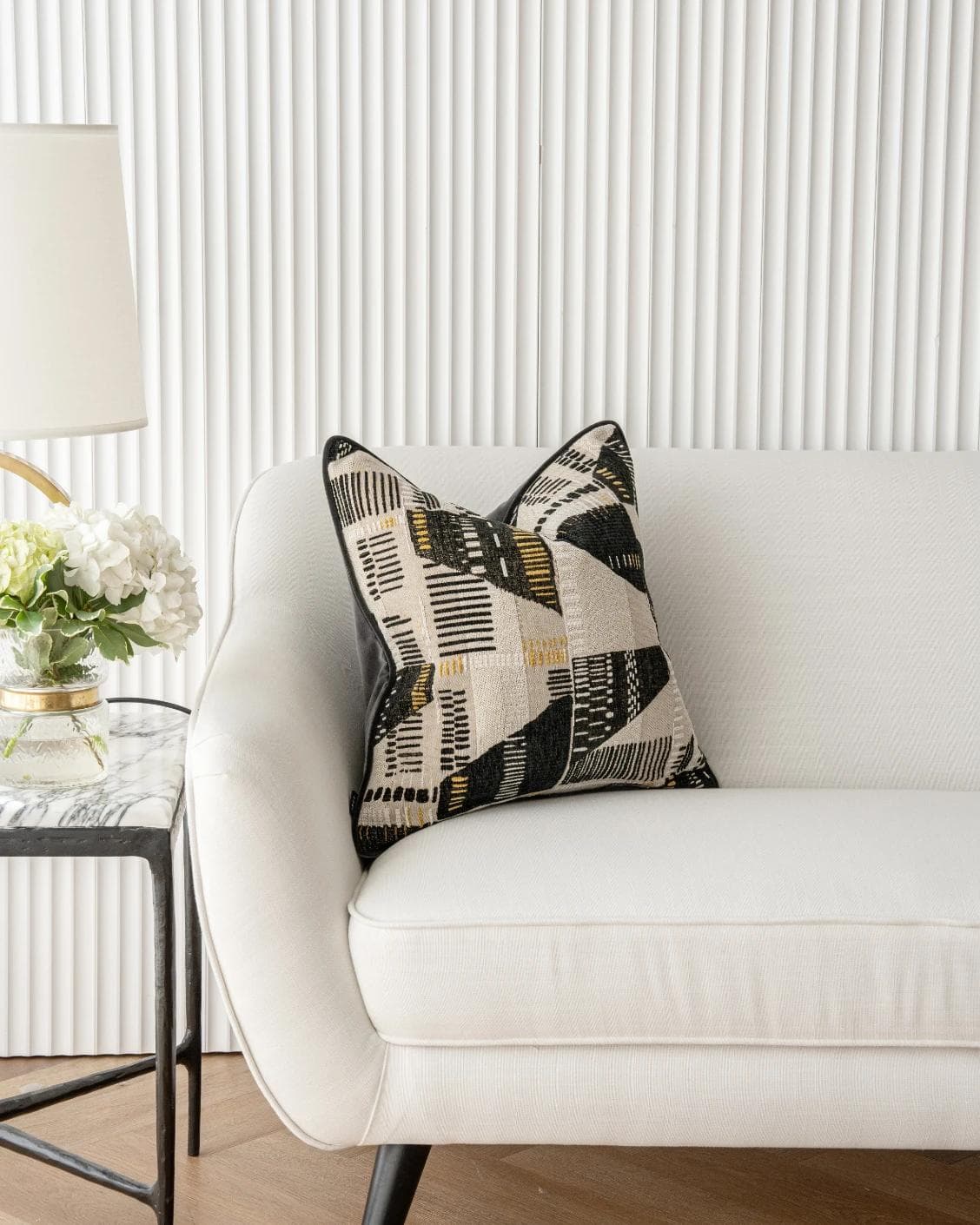 Hilda Steele cushion in black and beige, shown in a lifestyle front view as image 4