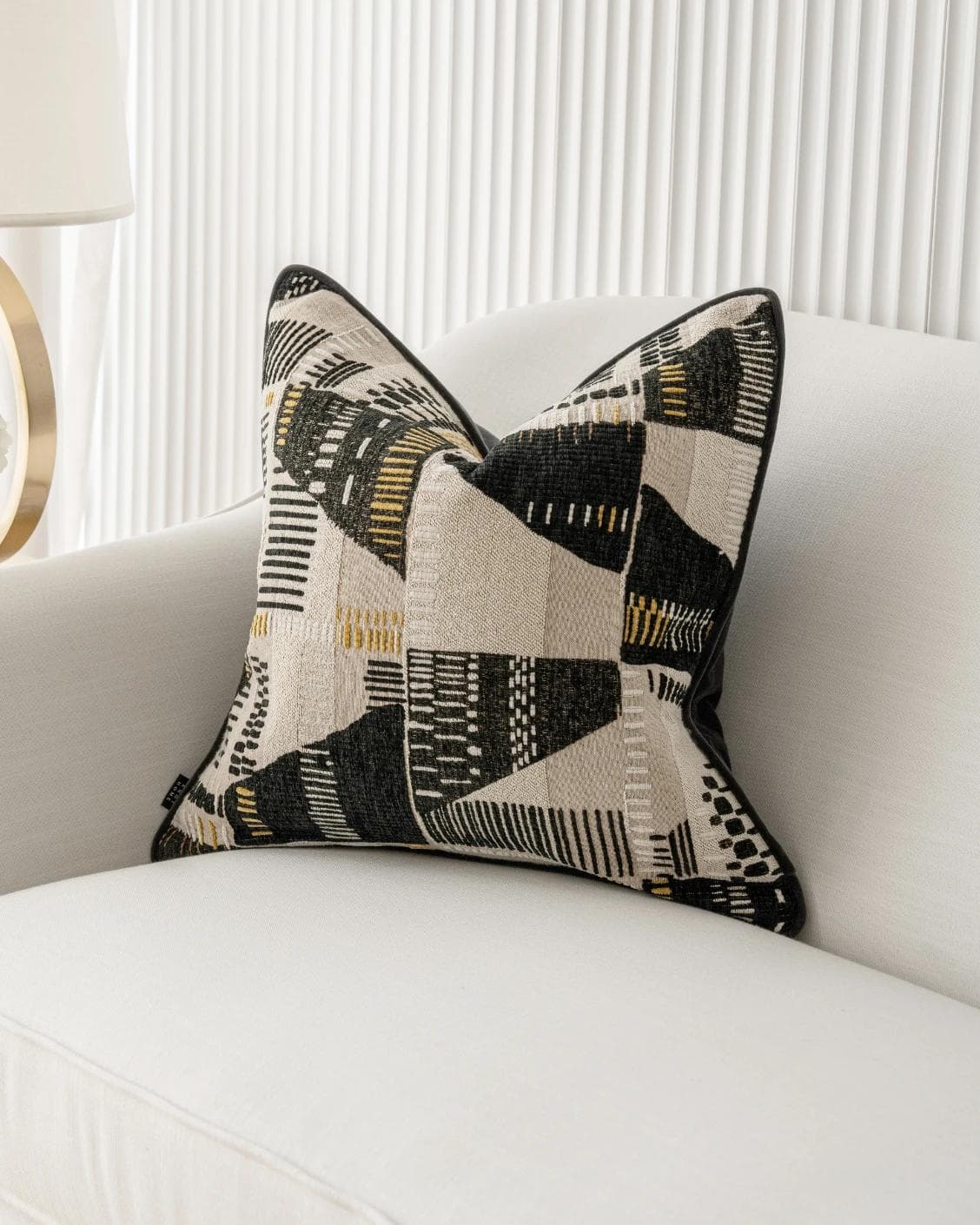 Hilda Steele cushion in black and beige, shown in a lifestyle front view as image 2