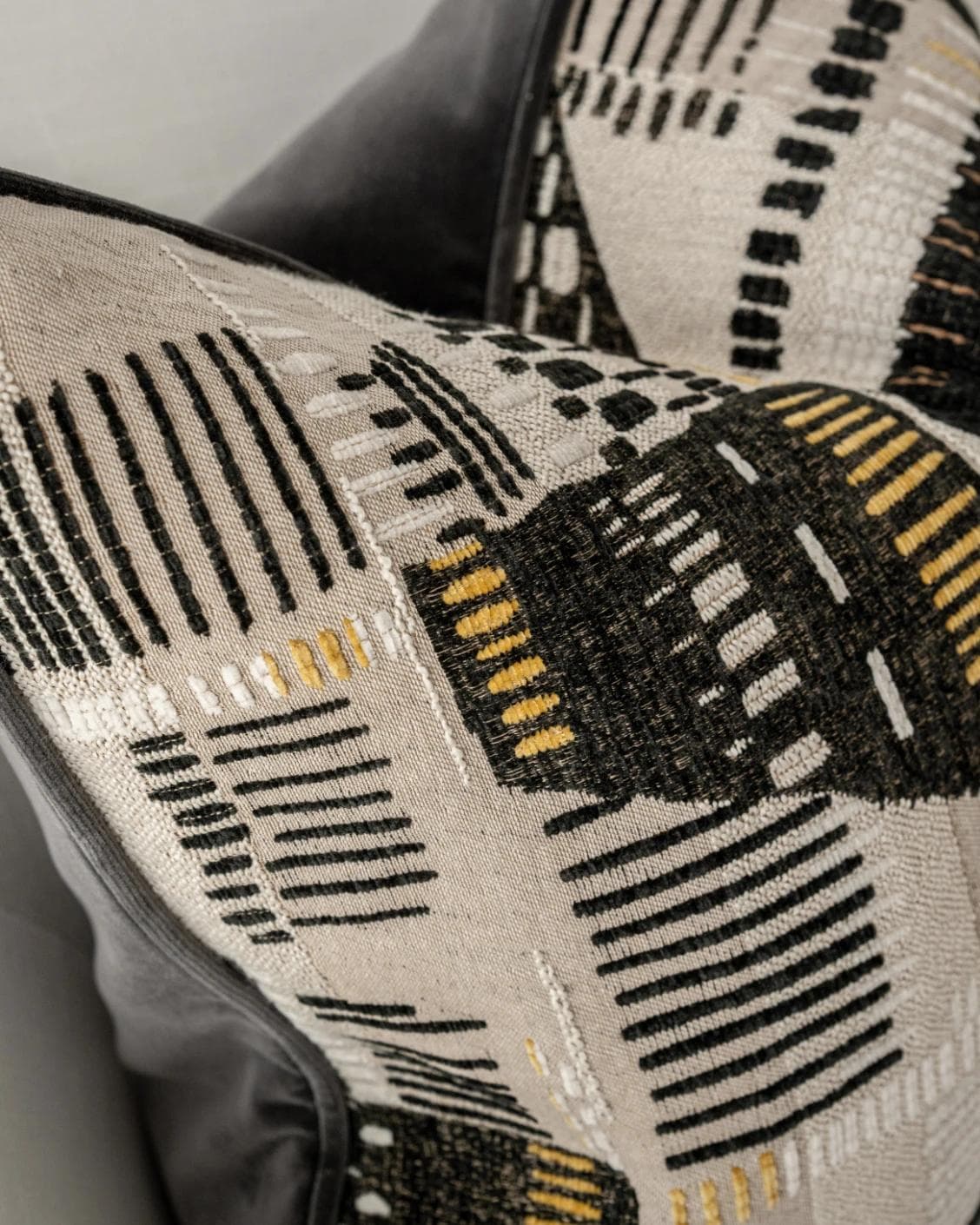 Hilda Steele cushion in black and beige, shown in a lifestyle top view as image 6
