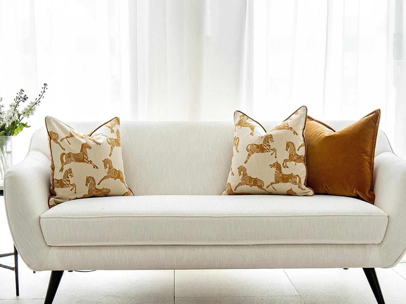 Arie Bundle cushion in orange and beige, shown in a lifestyle front view as image 4