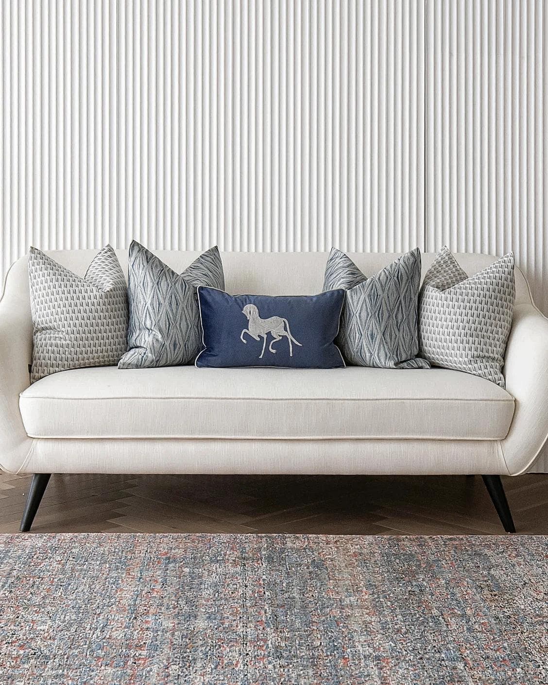 Edwin Bundle cushion in blue, silver and white, shown in a lifestyle front view as image 4