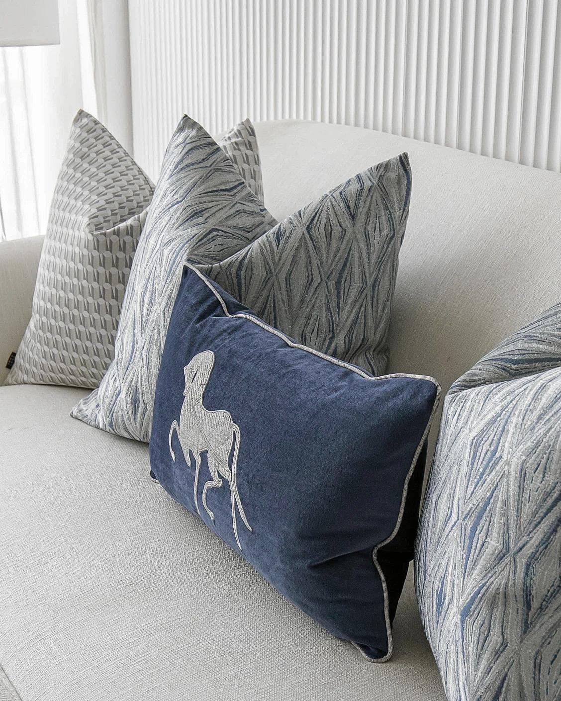Edwin Bundle cushion in blue, silver and white, shown in a product right view as image 5
