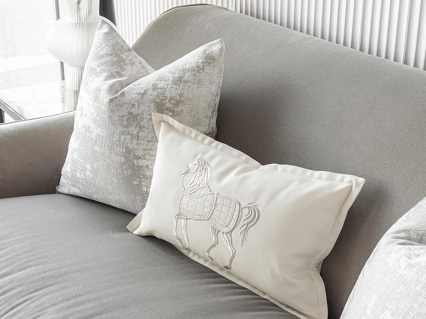 Klaus Bundle cushion in silver, grey and white, shown in a lifestyle right view as image 5