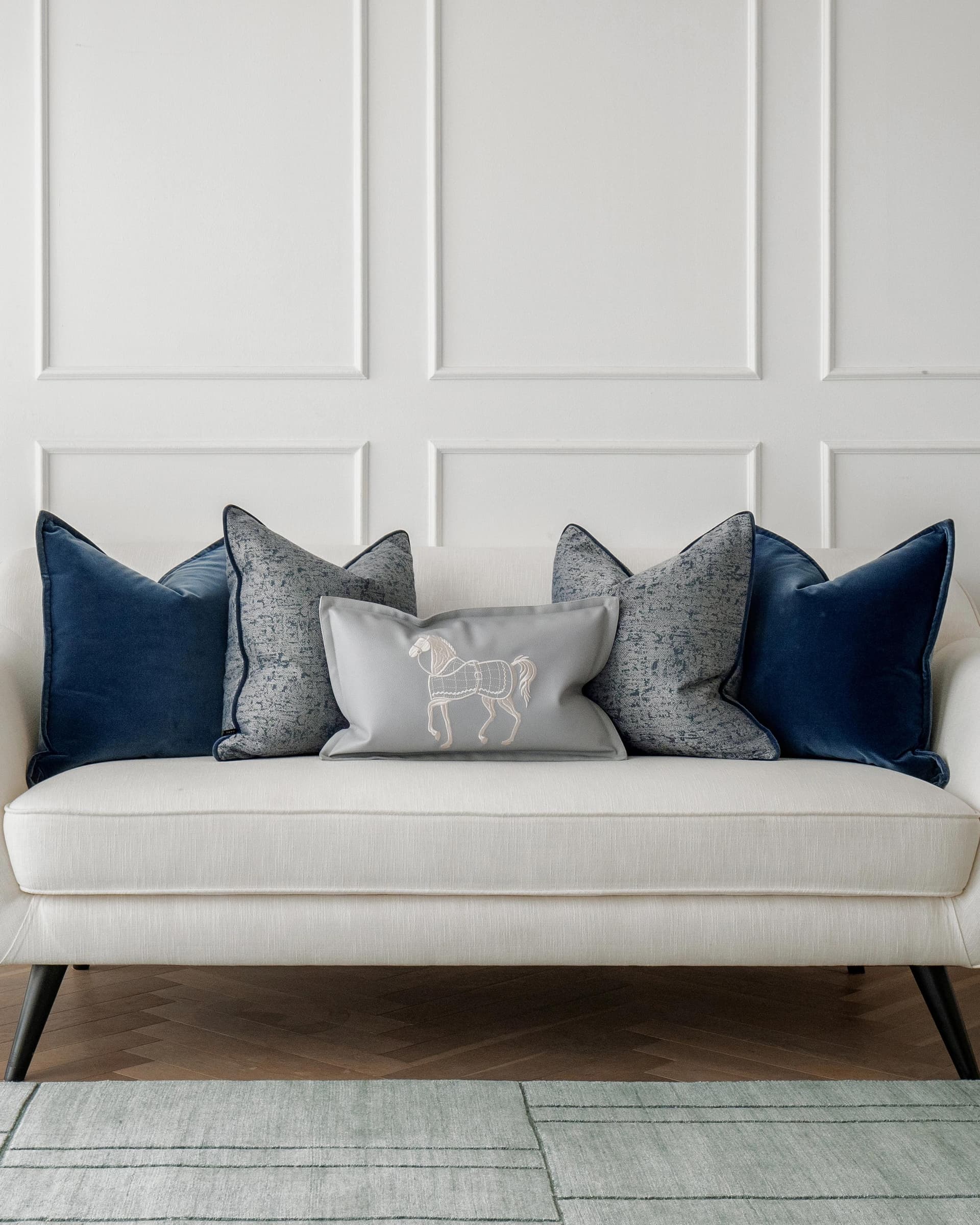 John Bundle cushion in blue, silver and white, shown in a lifestyle front view as image 4