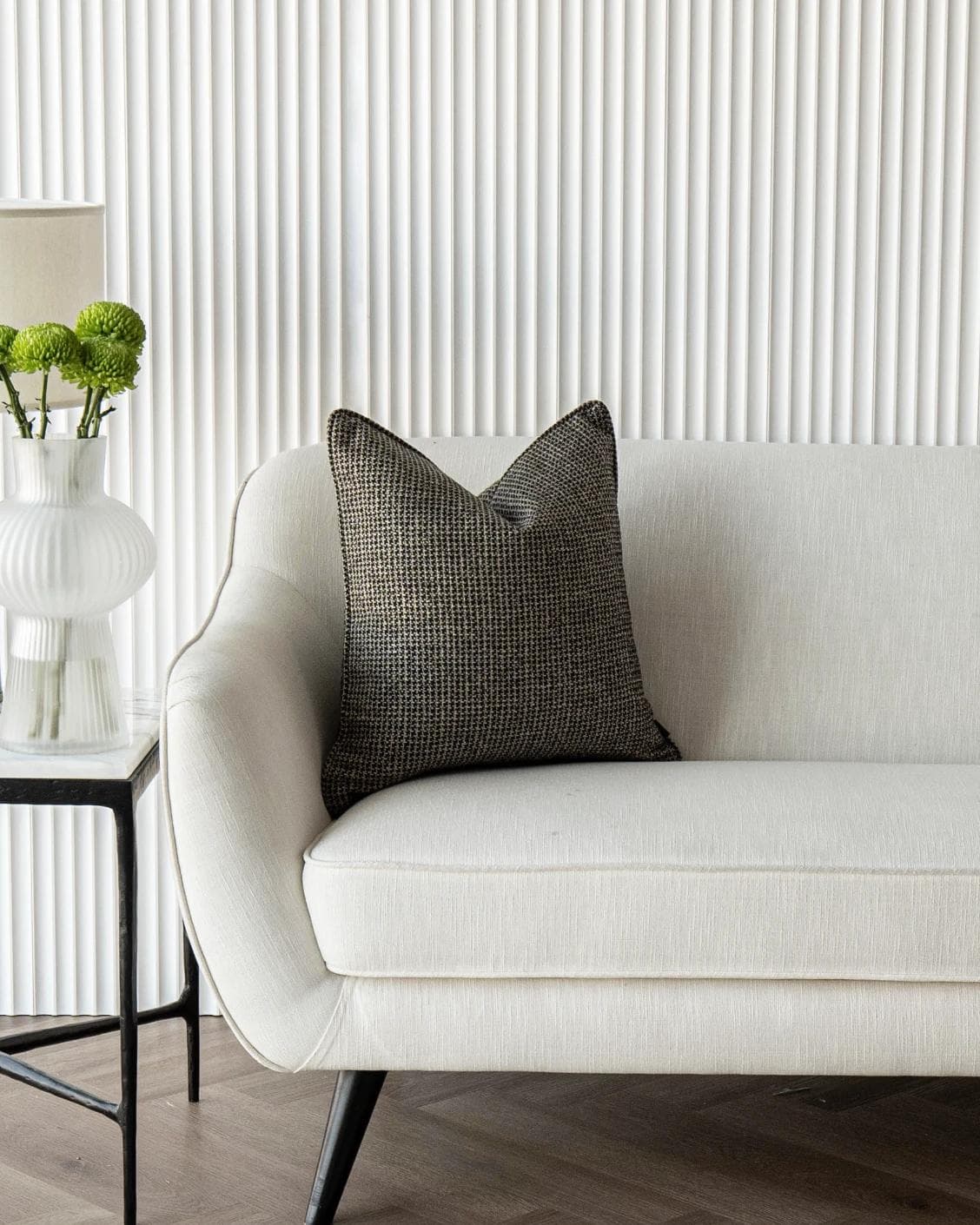 Hugo Steele cushion in black, shown in a lifestyle front view as image 4