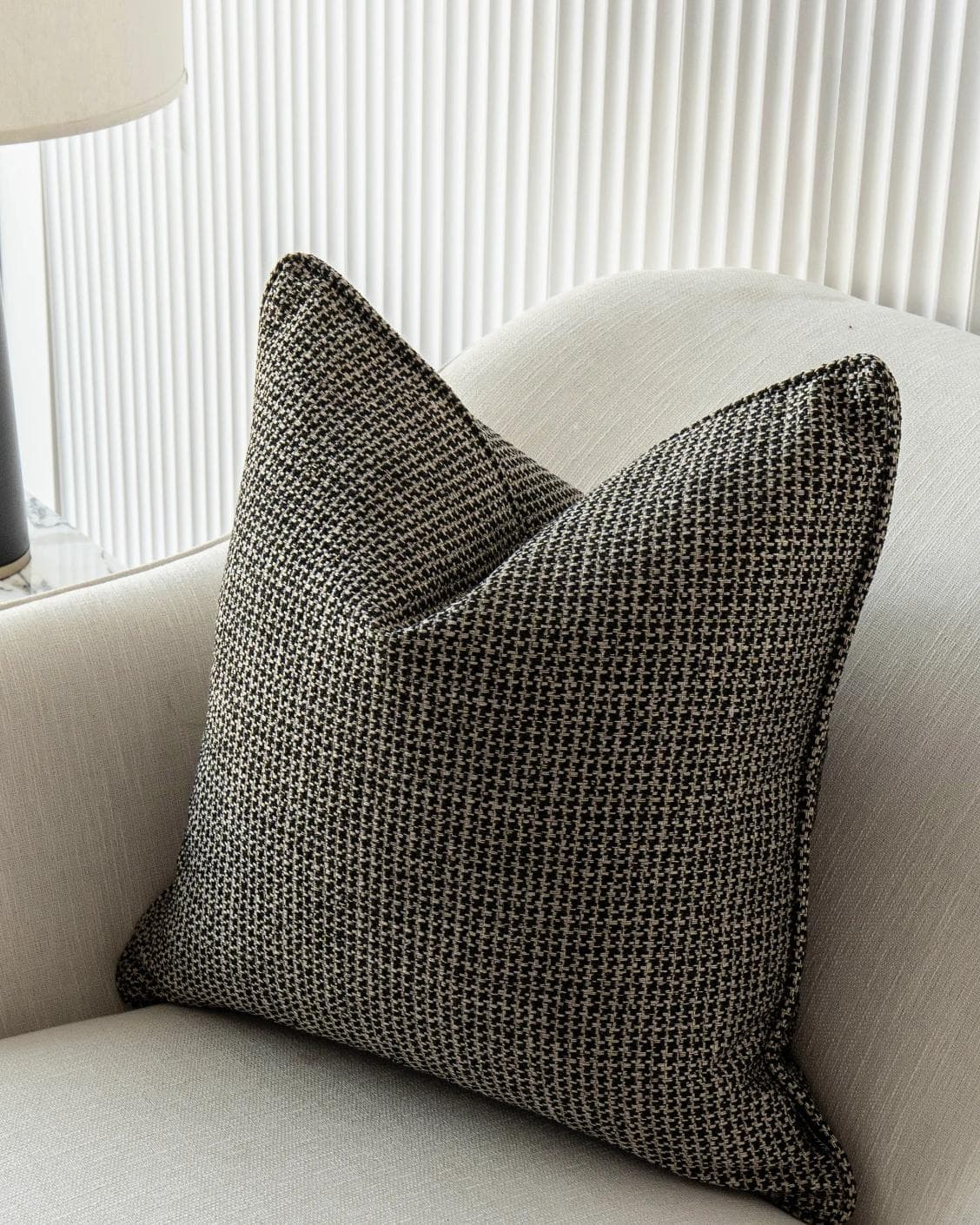 Hugo Steele cushion in black, shown in a lifestyle front view as image 5