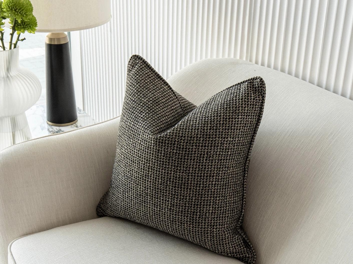 Hugo Steele cushion in black, shown in a lifestyle front view as image 5