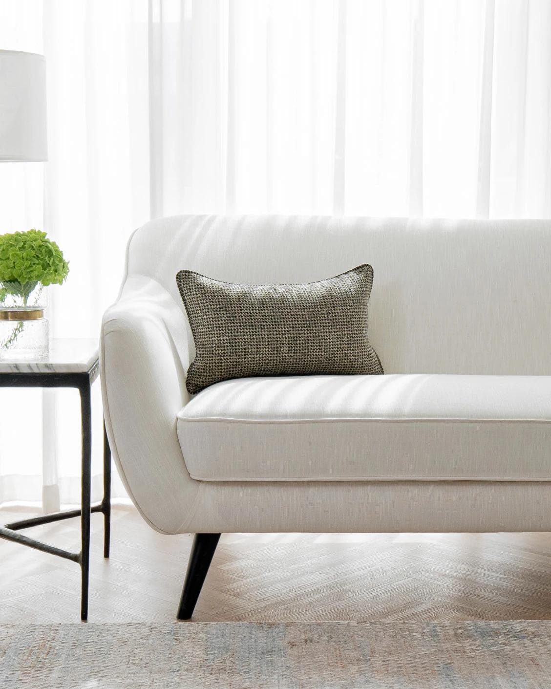 Hugo Steele II cushion in black, shown in a lifestyle front view as image 4