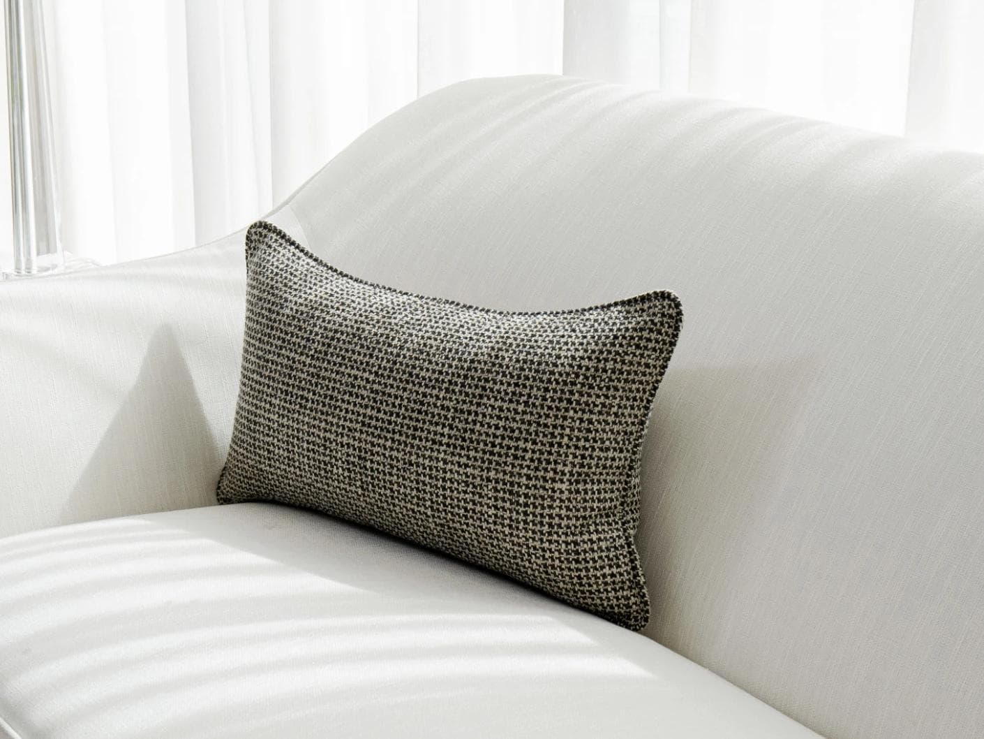 Hugo Steele II cushion in black, shown in a lifestyle front view as image 2