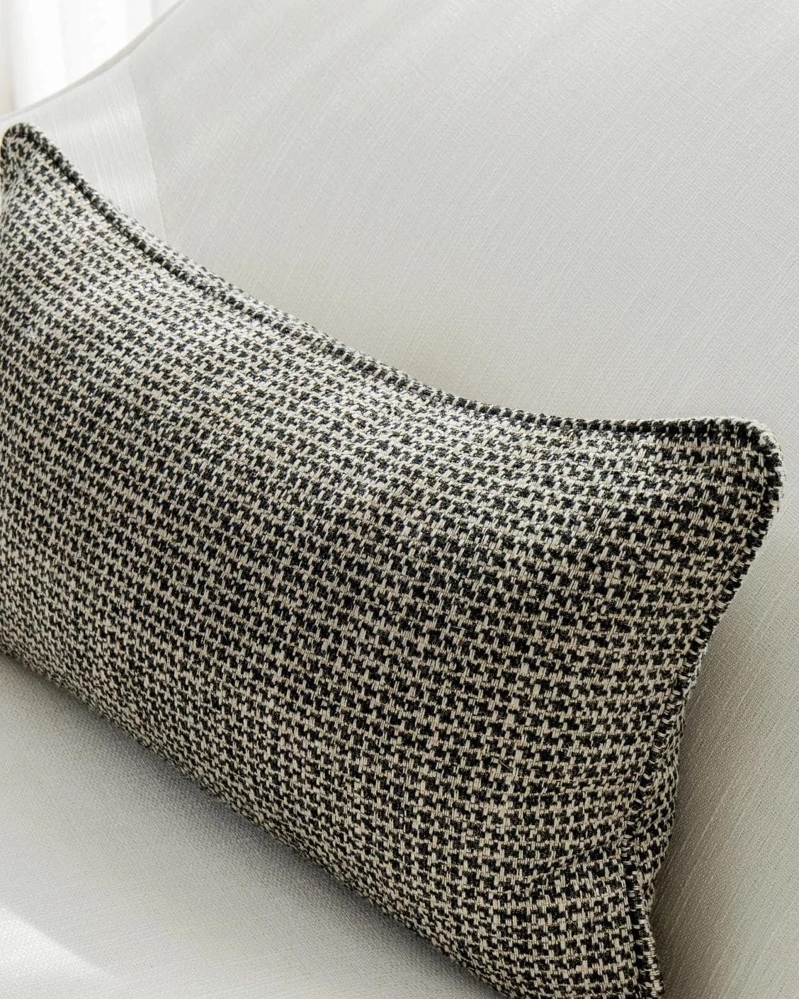 Hugo Steele II cushion in black, shown in a lifestyle top view as image 5