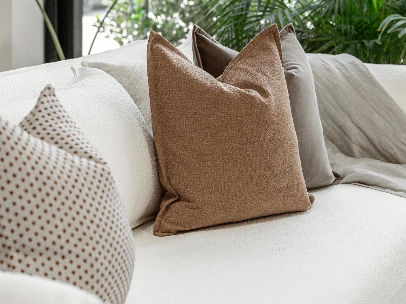 Abhishek Bundle cushion in brown and rust, shown in a lifestyle left view as image 6