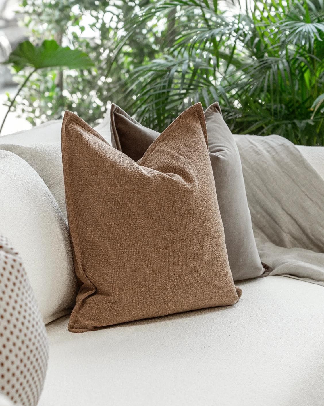 Abhishek Bundle cushion in brown and rust, shown in a lifestyle left view as image 6