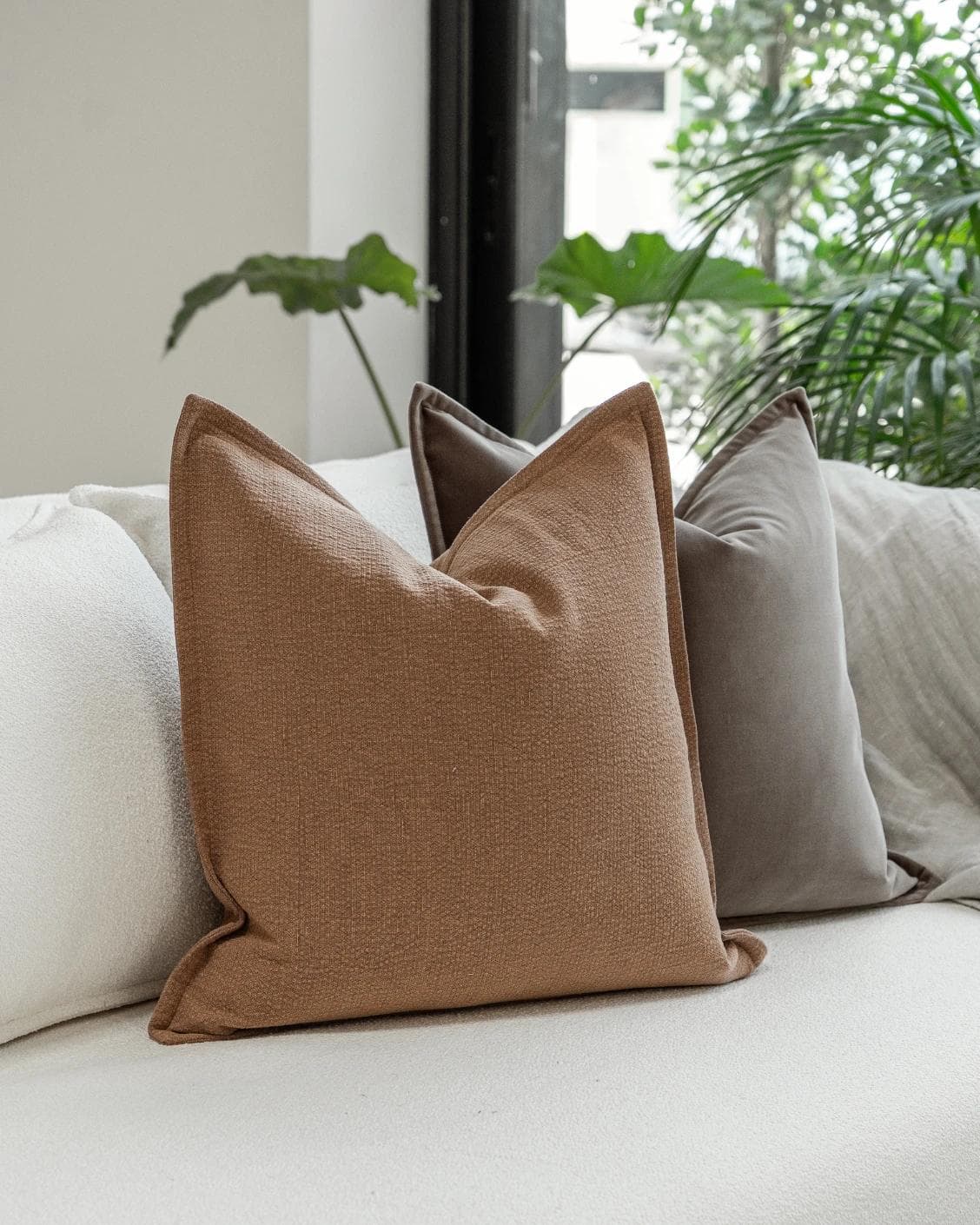 Abhishek Bundle cushion in brown and rust, shown in a lifestyle left view as image 5