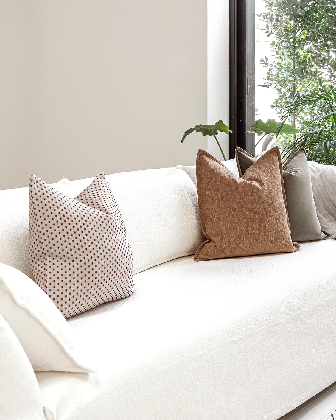Abhishek Bundle cushion in brown and rust, shown in a lifestyle left view as image 2