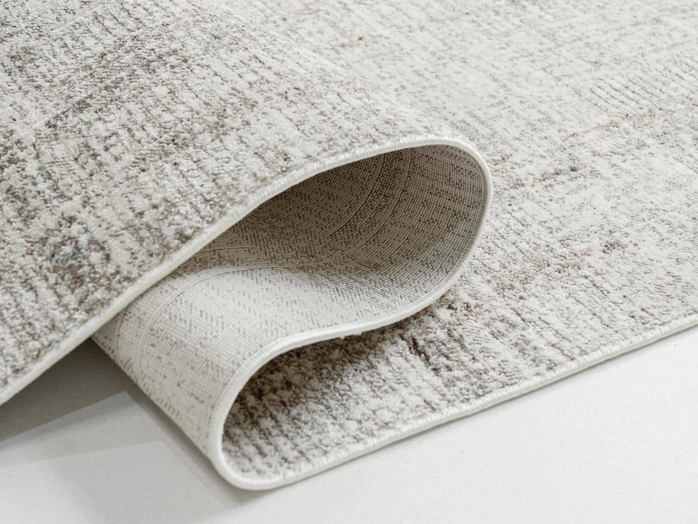 Ada Ivory carpets in ivory and taupe, shown in a product close-up left view