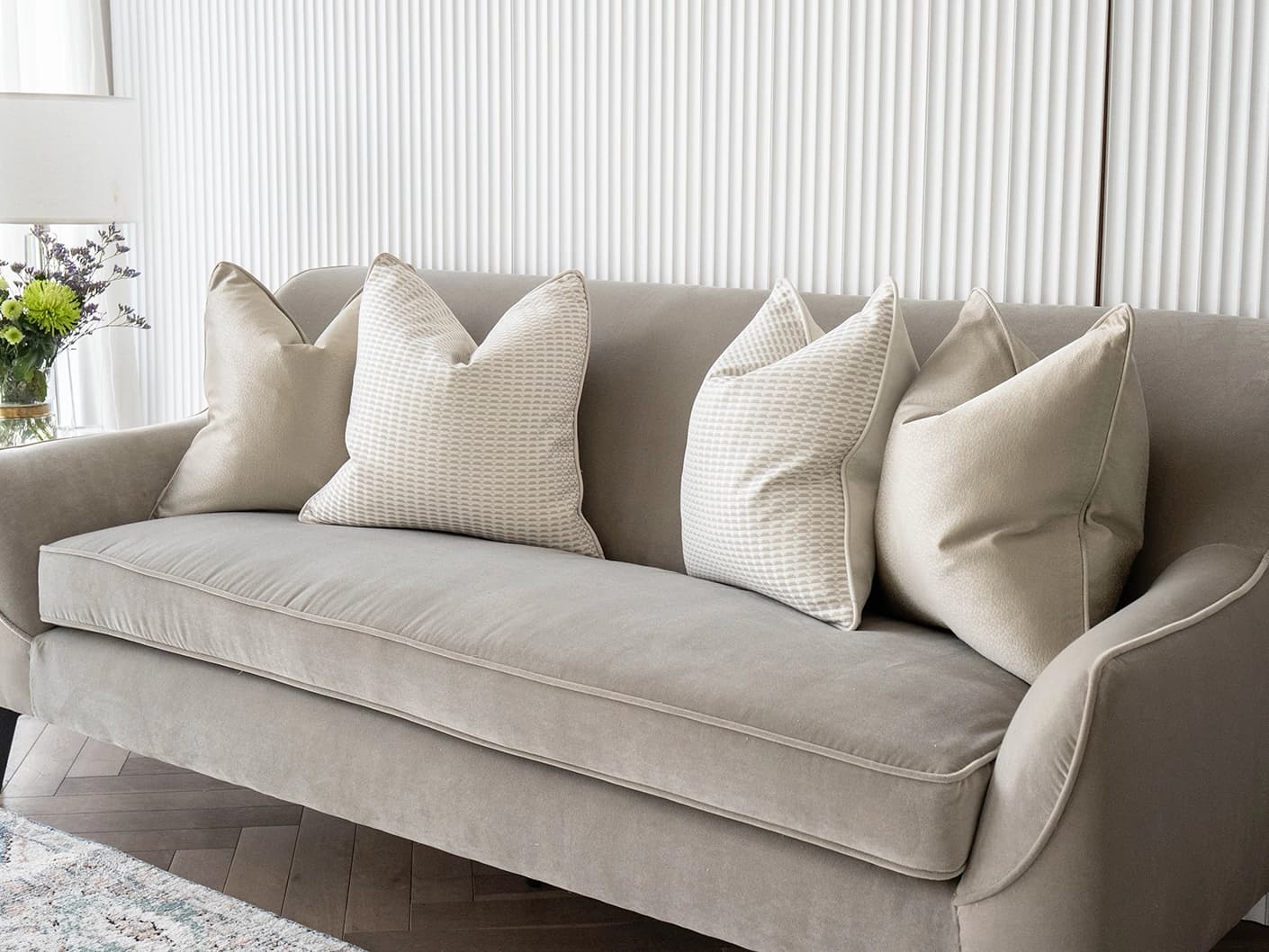 Adeline Bundle bundle cushions in gold, beige and white, shown in a lifestyle front view