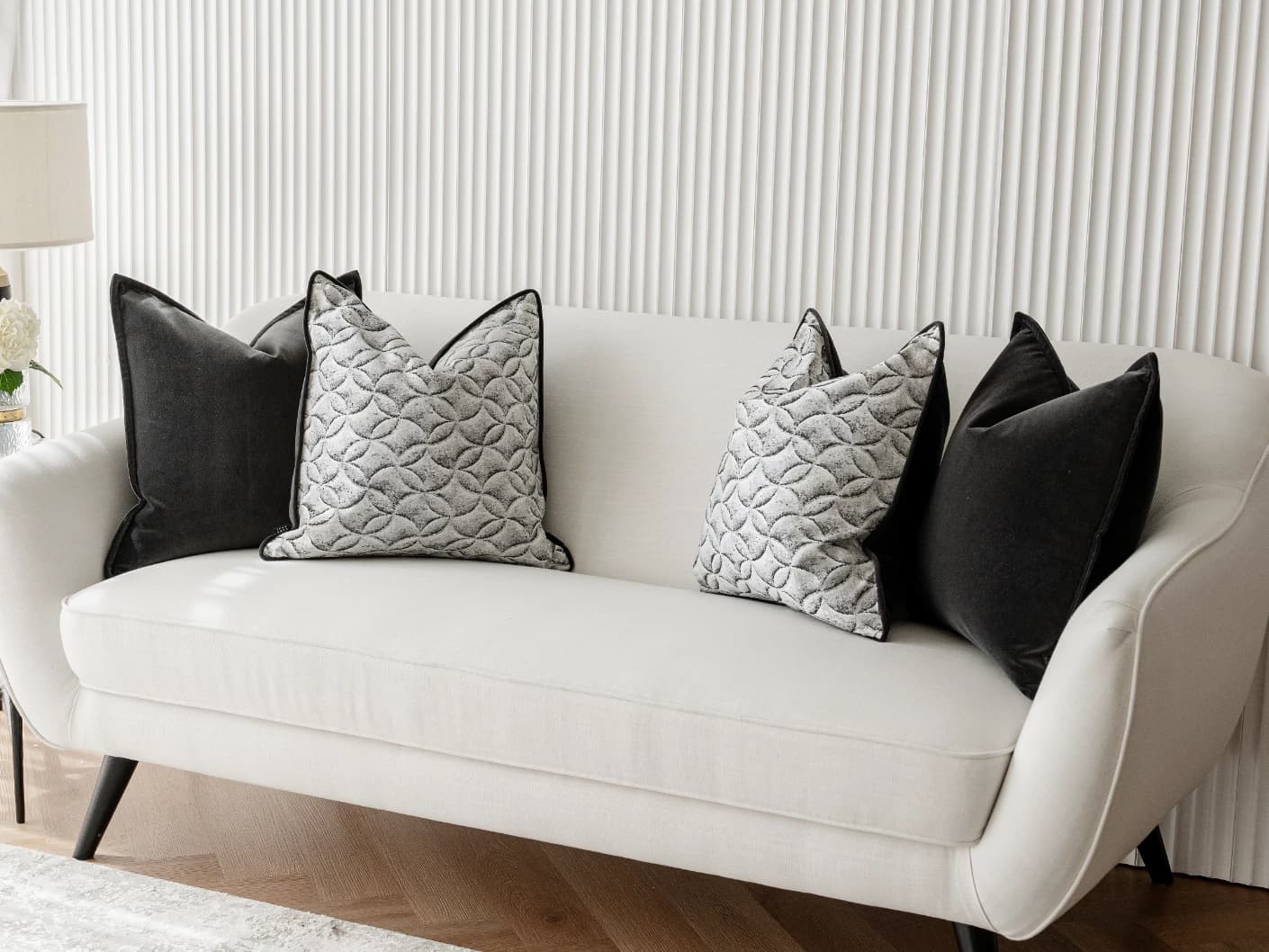 Adham Bundle bundle cushions in black, grey and white, shown in a lifestyle front view