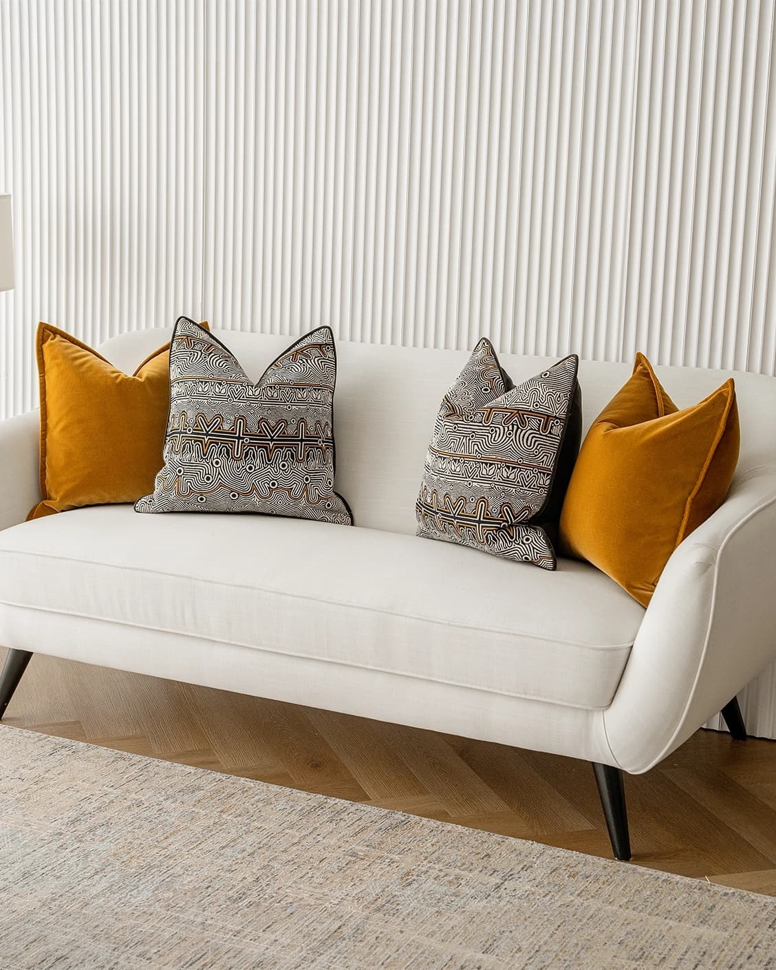 Adin Bundle cushion in orange, black and silver, shown in a lifestyle right view as image 2