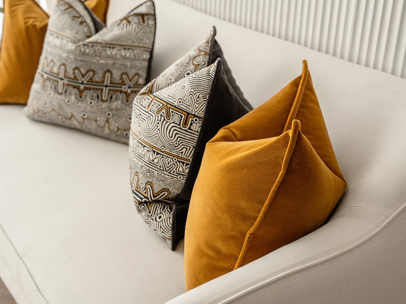 Adin Bundle cushion in orange, black and silver, shown in a lifestyle right view as image 6