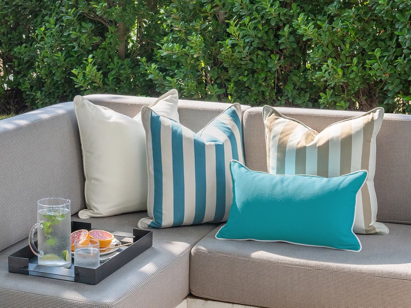 Aditya Bundle bundle cushions in turquoise, beige and ivory, shown in a lifestyle front view
