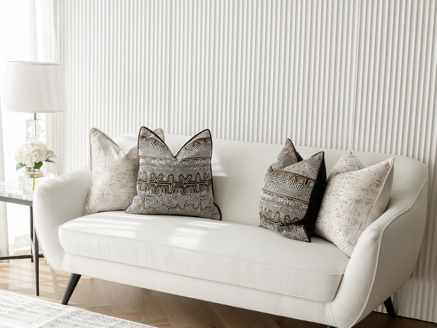 Adonis Bundle bundle cushions in white, black and silver, shown in a lifestyle front view