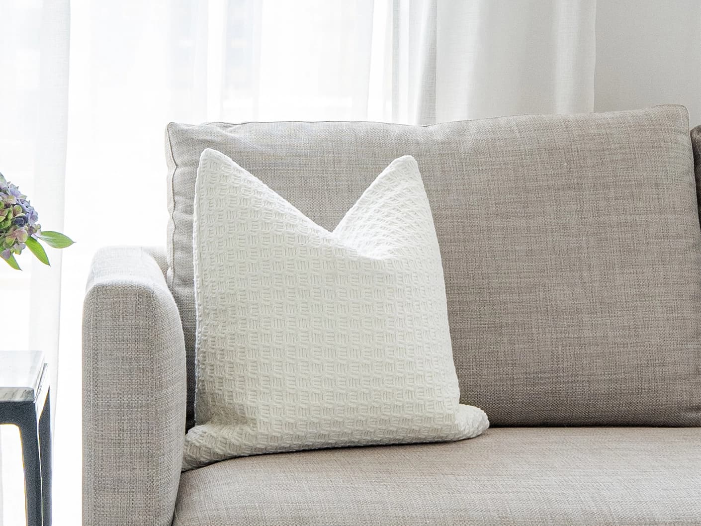 Adora Bianca single cushions in white, shown in a lifestyle front view
