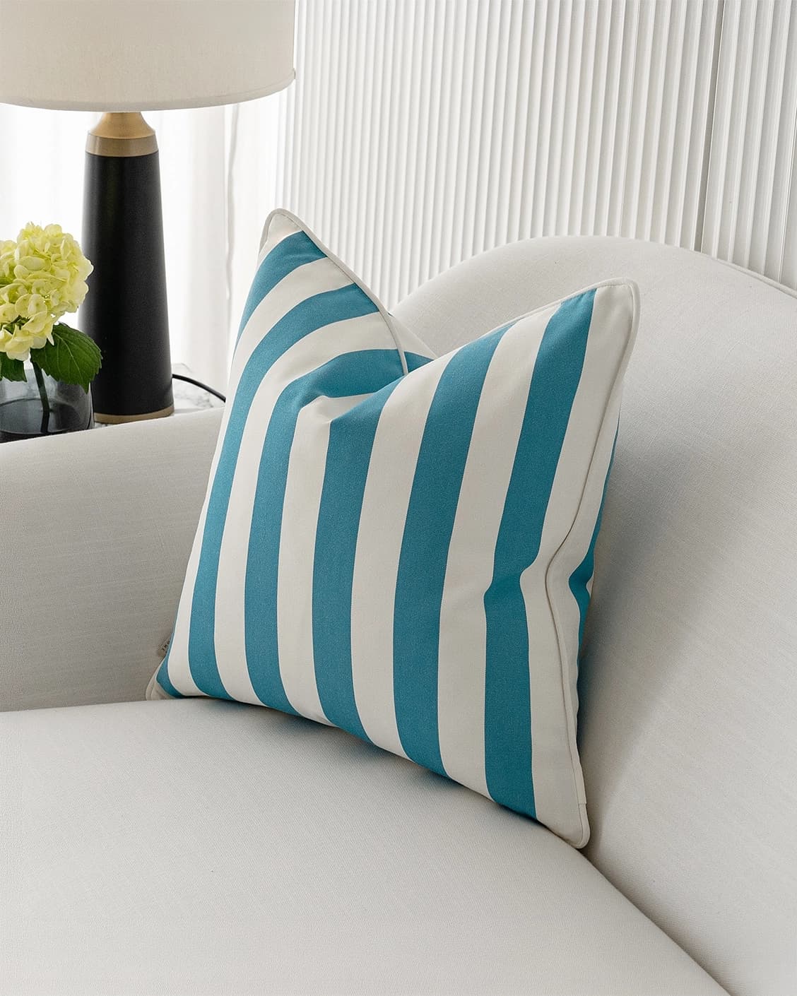 Aelia Azure cushion in blue and soft ivory, shown in a lifestyle right view as image 2
