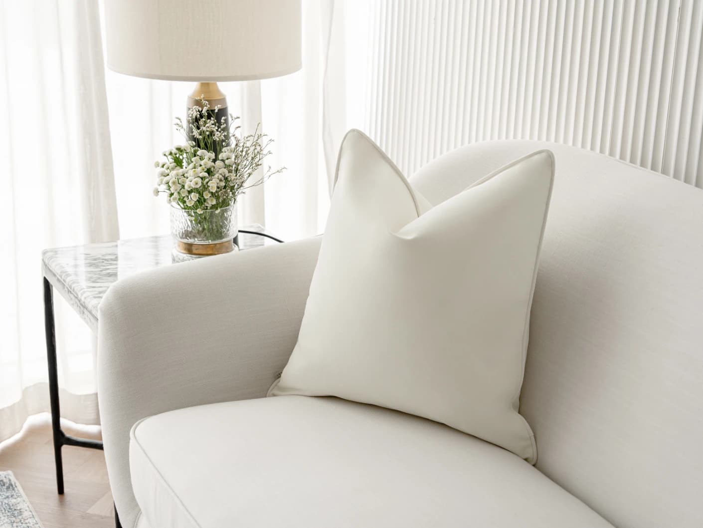 Aelia Bianca single cushions in soft ivory and ivory, shown in a lifestyle right view