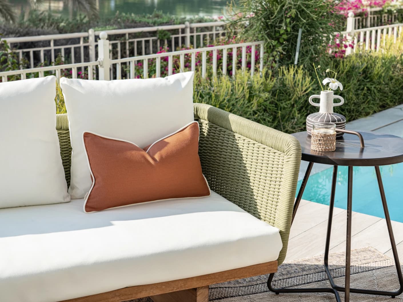 Aelia Clay II single cushions in clay and rust, shown in a lifestyle left view