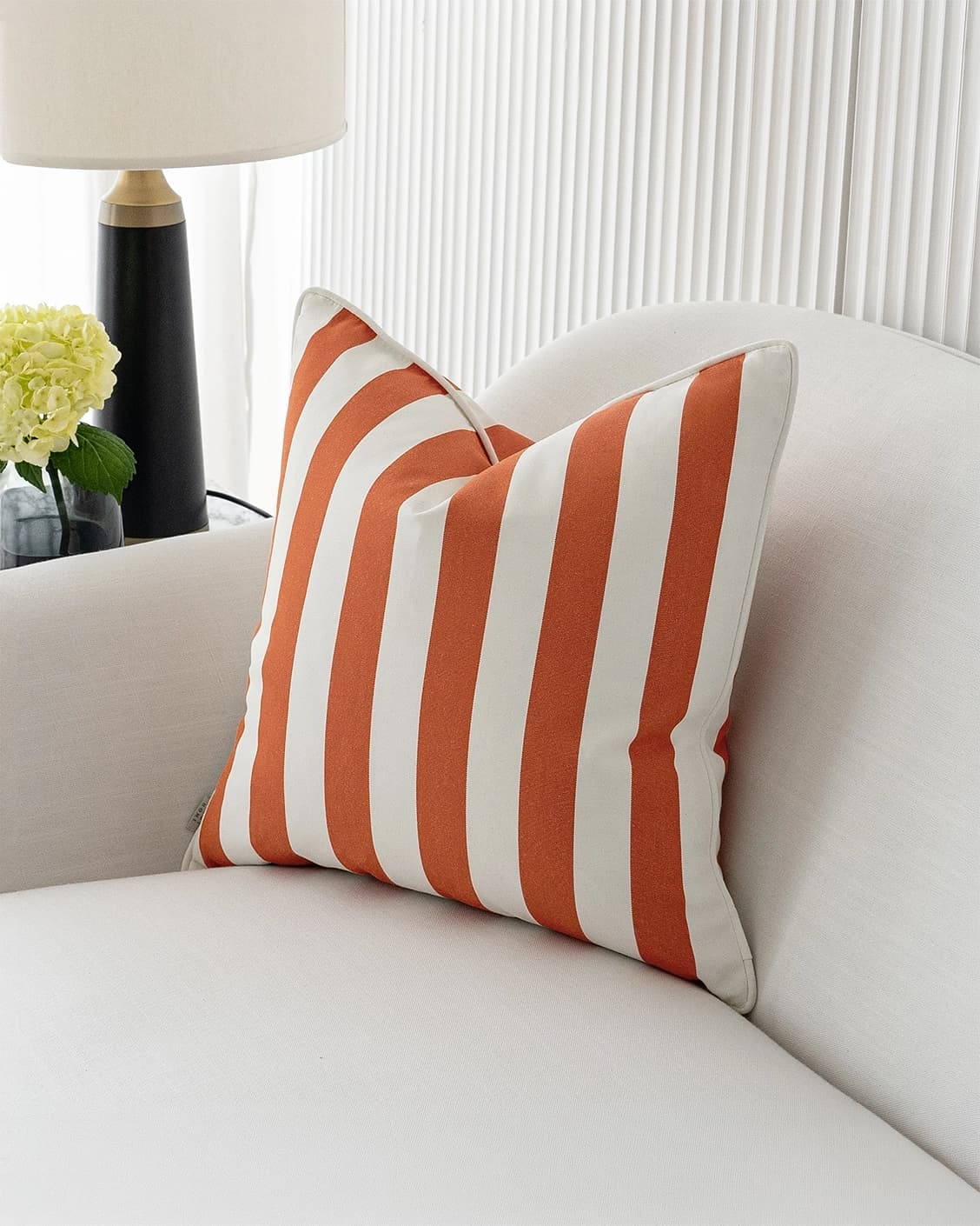 Aelia Coral cushion in orange, shown in a lifestyle right view as image 2