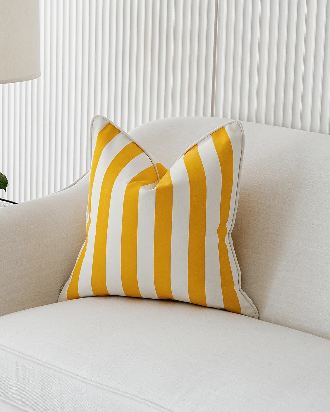 Aelia Gaze cushion in yellow, shown in a lifestyle front view as image 2