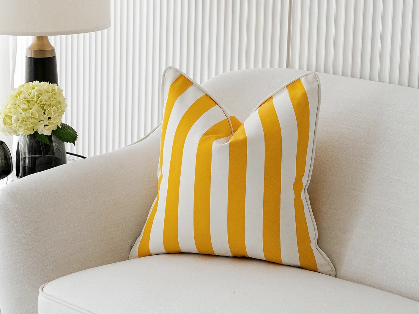 Aelia Gaze single cushions in yellow, shown in a lifestyle front view