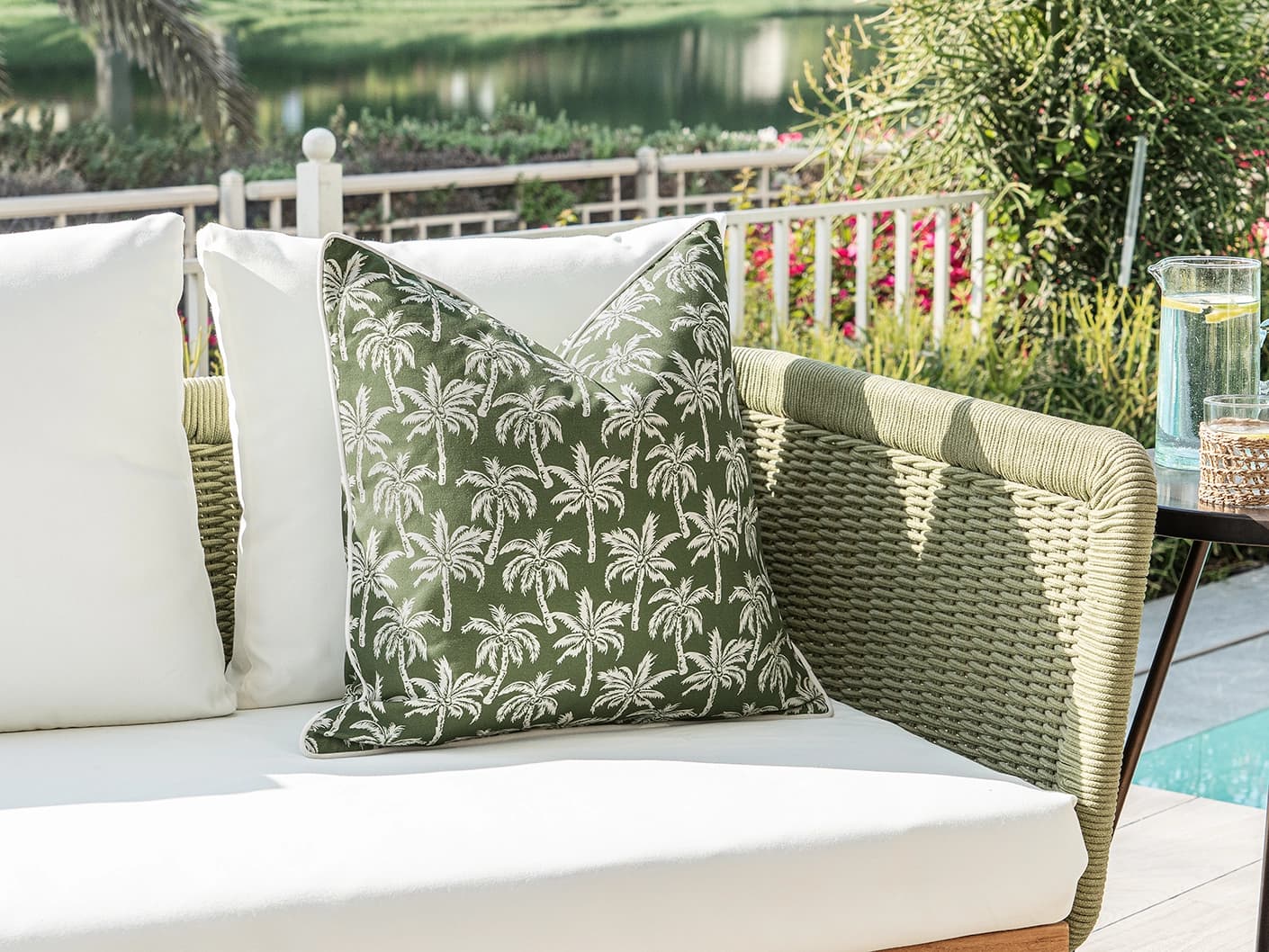 Aelia Palm single cushions in green, shown in a lifestyle left view
