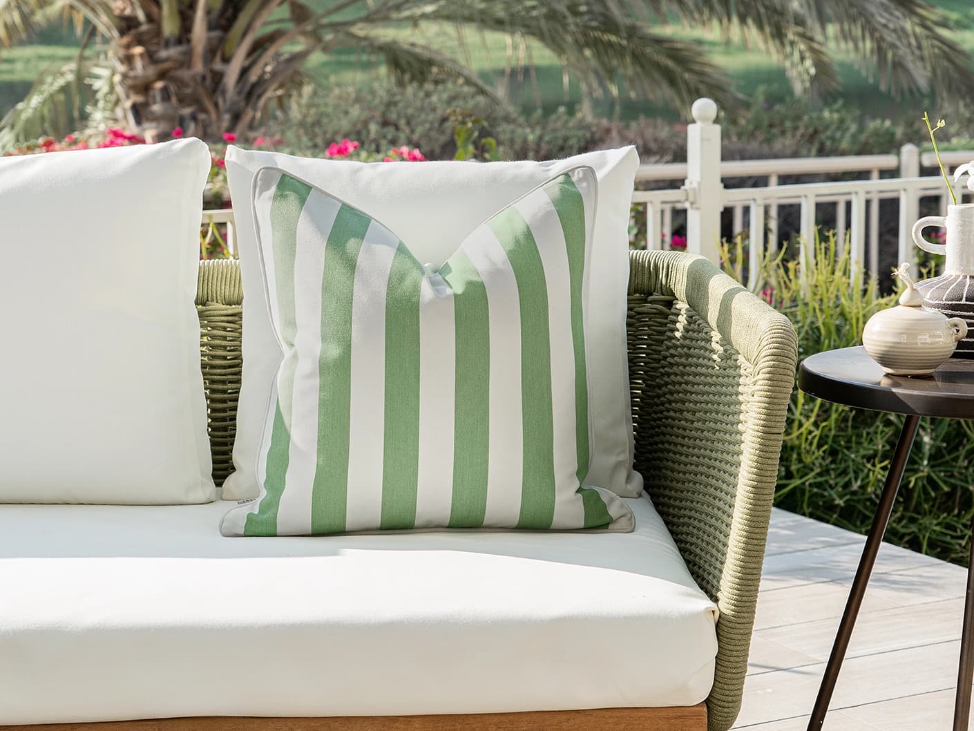 Aelia Pistachio single cushions in pistachio, forest green and green, shown in a lifestyle front view