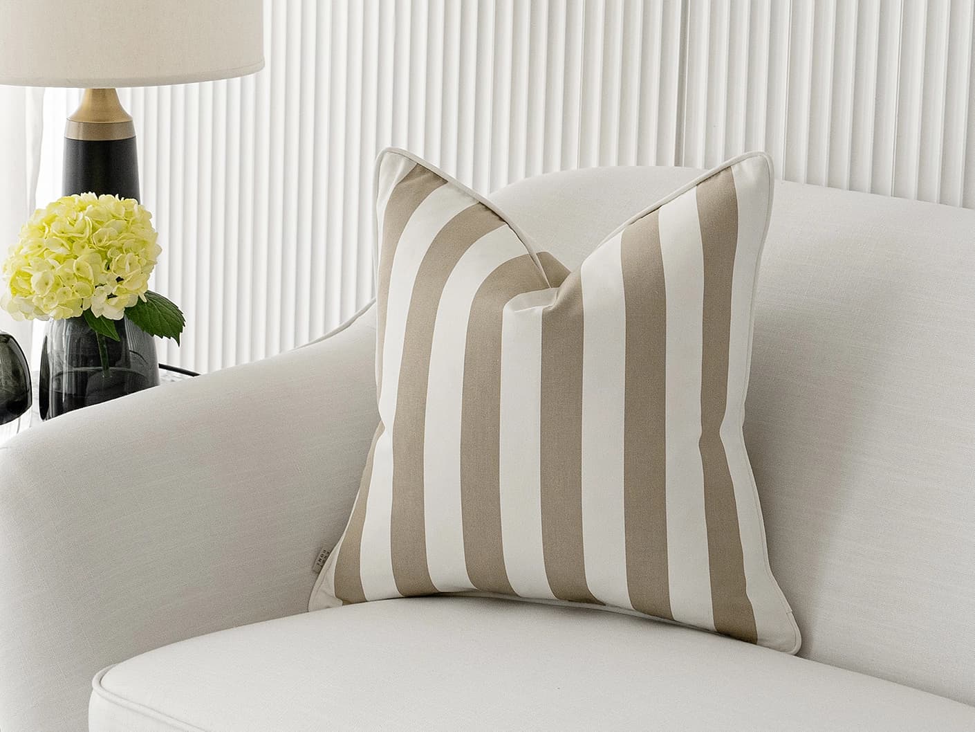 Aelia Sandy single cushions in sandy and beige, shown in a lifestyle front view