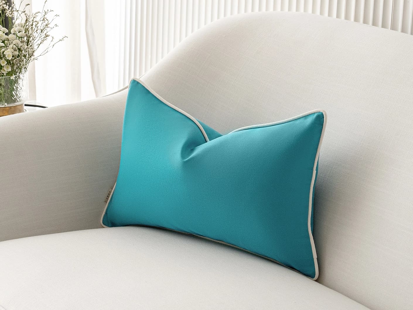 Aelia Sky II single cushions in sky, coral and blue, shown in a lifestyle right view