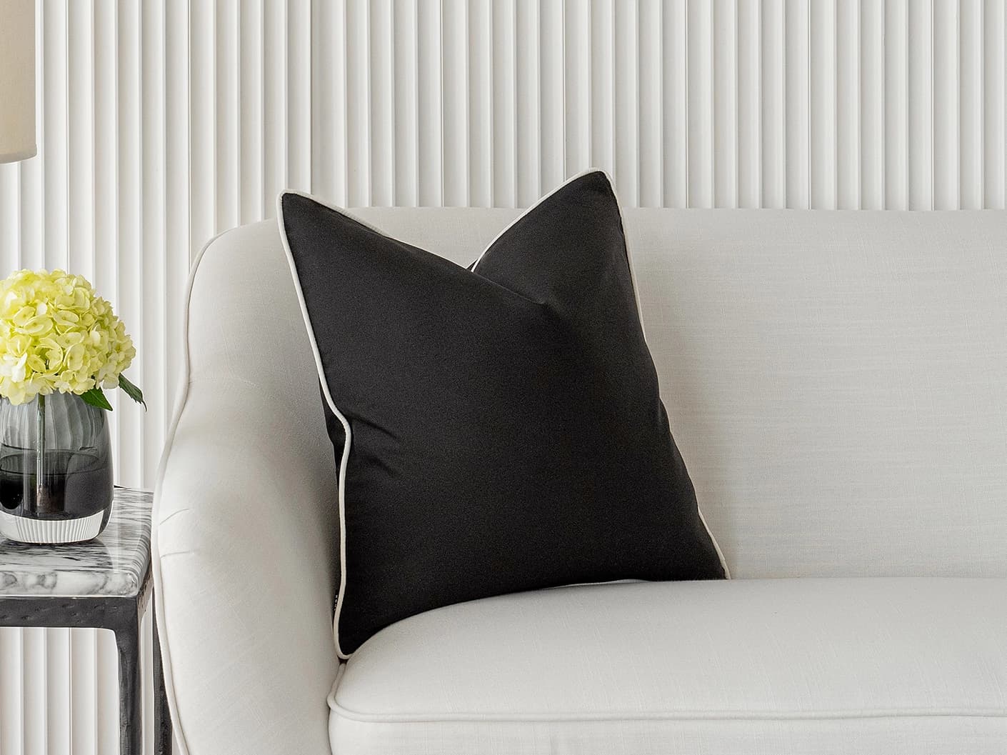 Aelia Steele single cushions in black, shown in a lifestyle front view
